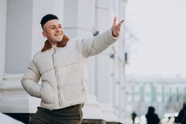 Jovem de casaco de inverno branco fora da rua