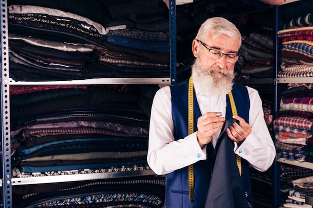 Jovem designer de moda masculina concentrado no trabalho em um estúdio