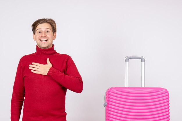 Jovem do sexo masculino com bolsa rosa em fundo branco