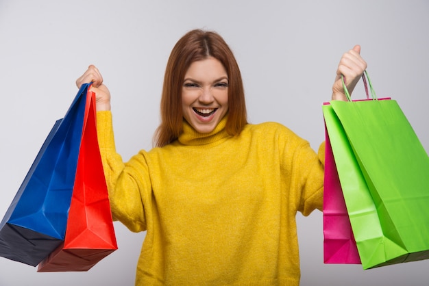 Jovem feliz com sacolas coloridas