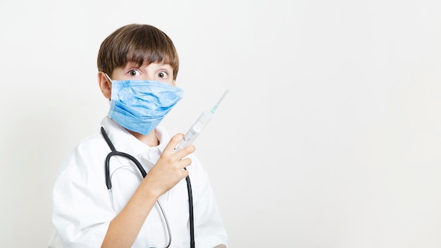 Foto grátis jovem garoto posando como médico