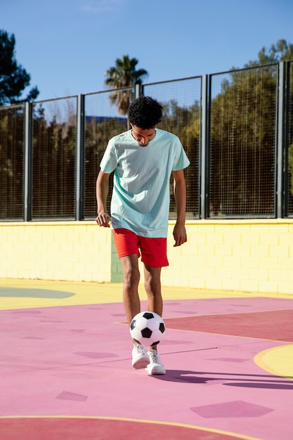 Foto grátis jovem jogando futebol