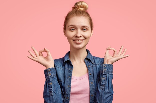 Foto grátis jovem loira com cabelo preso em um coque e camisa jeans