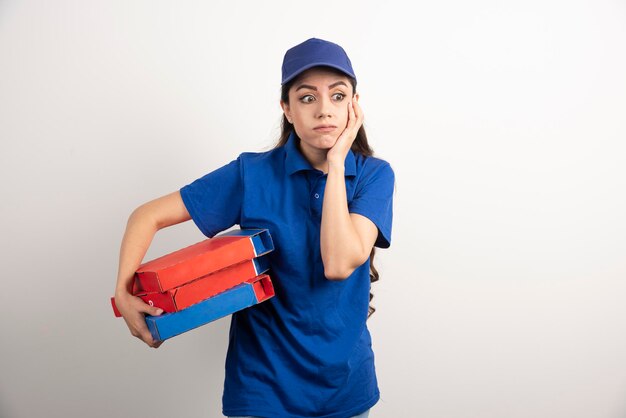 Jovem mensageira com papelão de pizza e prancheta