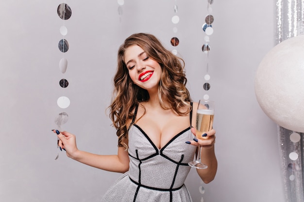 jovem modelo mulher com cabelo muito bonito e um sorriso lindo em seu vestido prata festivo