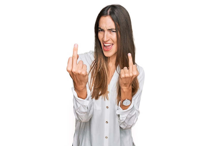 Foto grátis jovem mulher bonita vestindo roupas casuais, mostrando o dedo médio fazendo foda-se, expressão ruim, provocação e atitude rude. gritando animado