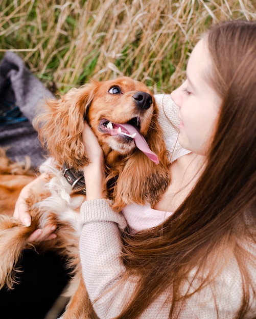 Jovem mulher brincando com seu cachorro