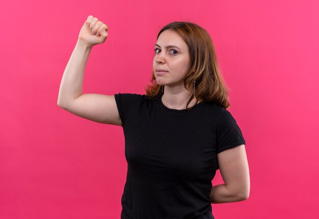 Jovem mulher casual gesticulando com força na parede rosa isolada