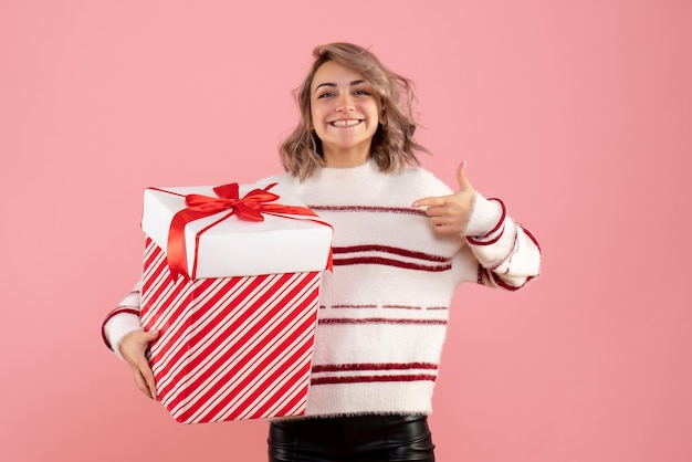 Jovem mulher com um presente de natal de frente