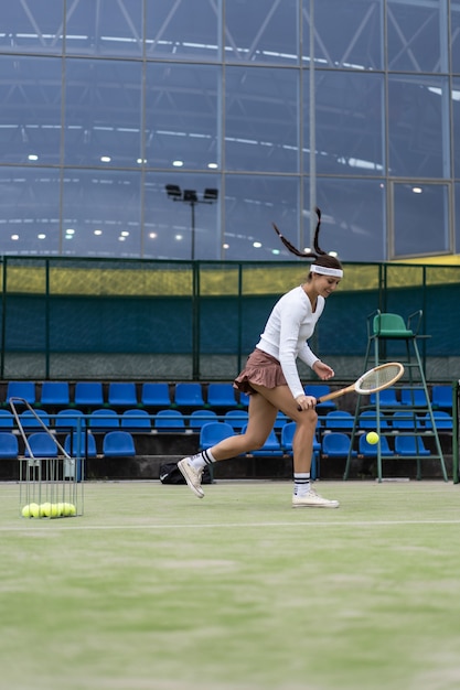 Foto grátis jovem mulher jogando tênis