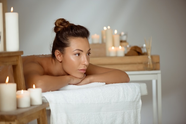 Jovem mulher nua relaxante no salão spa.