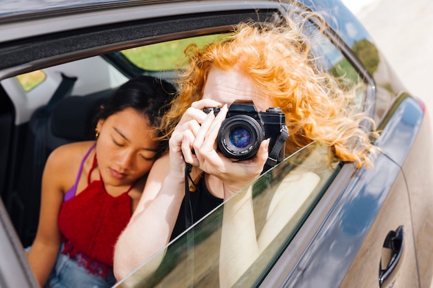 Jovem mulher tirando fotos na câmera