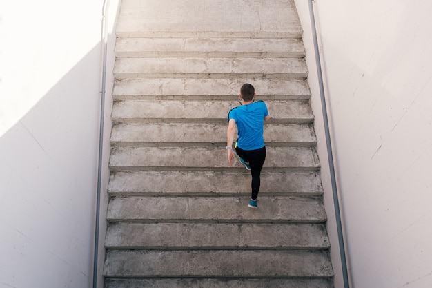 Foto grátis jovem praticando exercícios de intervalo nas escadas