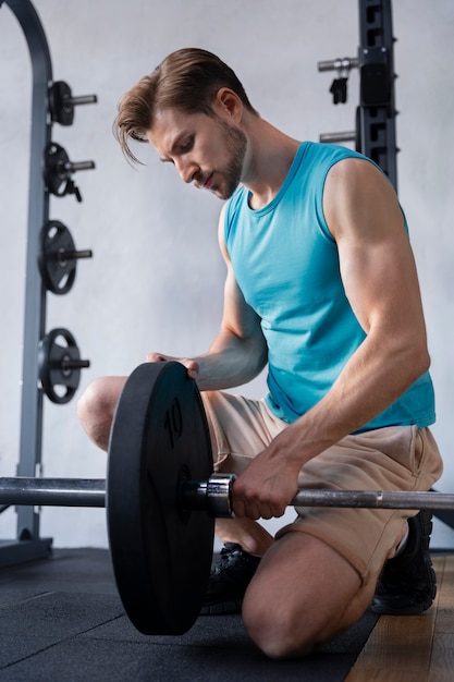 Foto grátis jovem se exercitando na academia de musculação