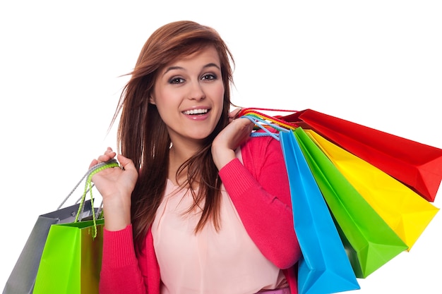 Jovem segurando sacolas de compras e sorrindo