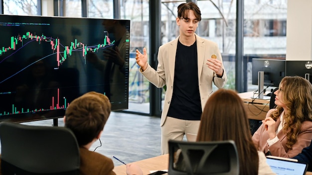 Foto grátis jovem trabalhador liderando reunião de negócios sobre criptomoedas em um escritório