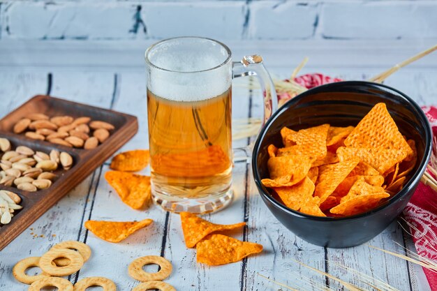 Lanches variados, batatas fritas e cerveja na mesa azul. Mesa para grupo de amigos.