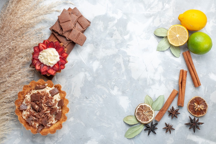 Foto grátis limões frescos suculentos e azedos com canela e bolos em uma mesa branca de frutas exóticas tropicais cítricas