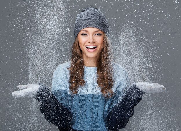 Linda garota com flocos de neve se divertindo