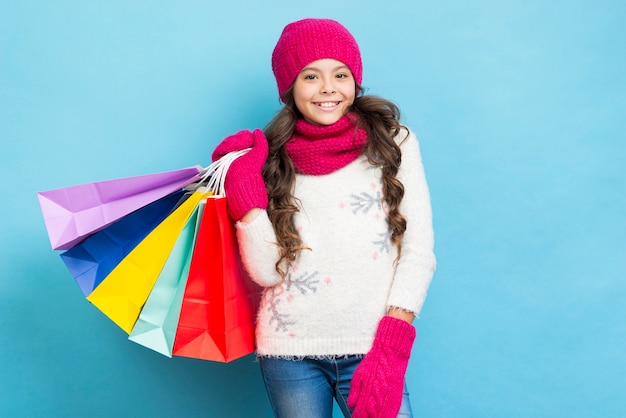 Linda garota com sacolas de compras no ombro