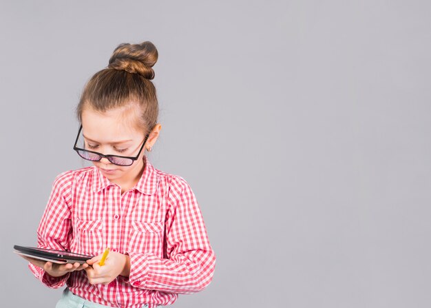 Linda garota de óculos usando tablet