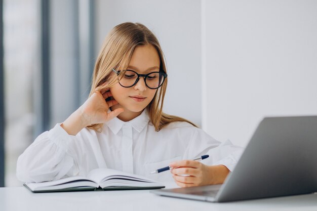 Linda garota estudando no computador em casa