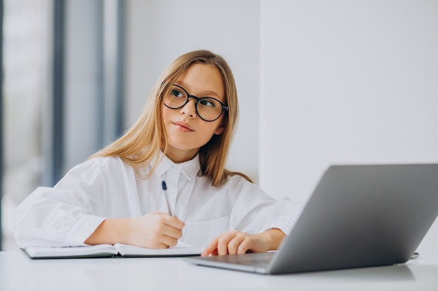 Linda garota estudando no computador em casa