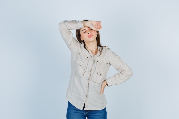 Foto grátis linda garota na camisa, sofrendo de dor de cabeça e parecendo angustiada.