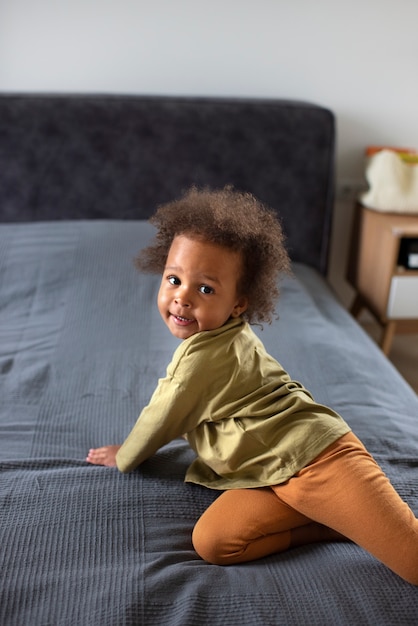 Foto grátis lindo bebê preto se divertindo em casa