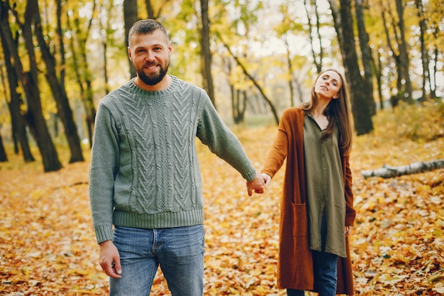 Lindo casal passa o tempo em um parque de outono