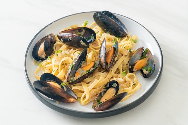 Linguine spaghetti pasta vongole molho de vinho branco - massa italiana de frutos do mar com amêijoas e mexilhões