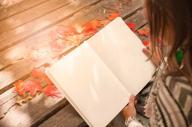 Livro de leitura de mulher anônima no parque outono