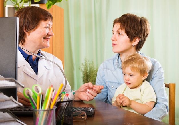 Mãe com bebê ouvindo médico pediatra