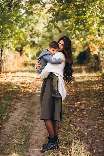 Mãe com filho pequeno em um parque de outono