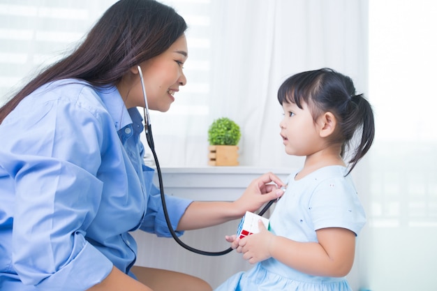 Mãe e filha brincando de médico com estetoscópio