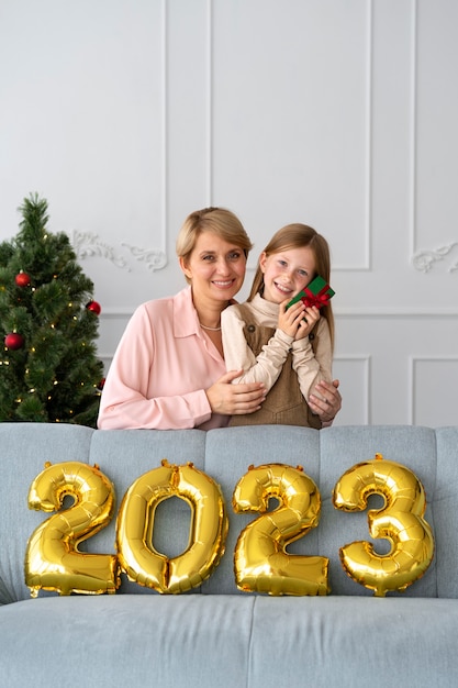 Foto grátis mãe e filha comemorando a véspera de ano novo em casa juntos