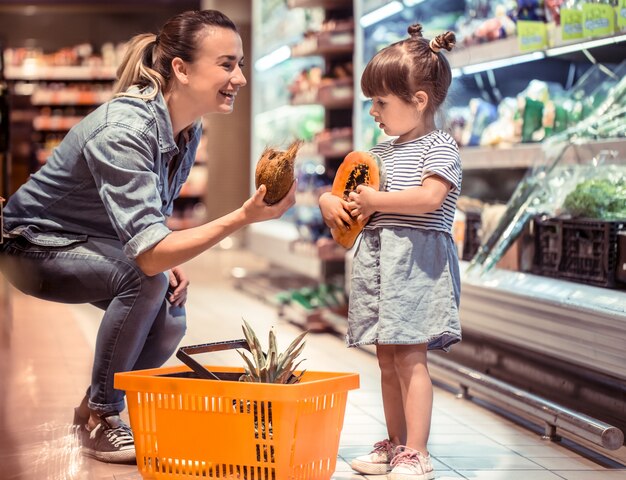 Mãe e filha estão fazendo compras no supermercado