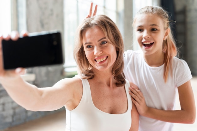 Mãe e filha tomando selfie engraçado