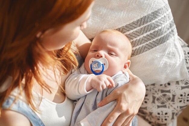 Mãe e filho posando em ambientes fechados