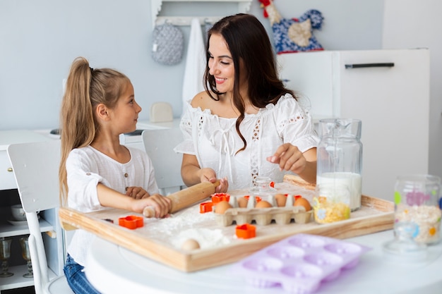 Mãe ensinando filha a cozinhar