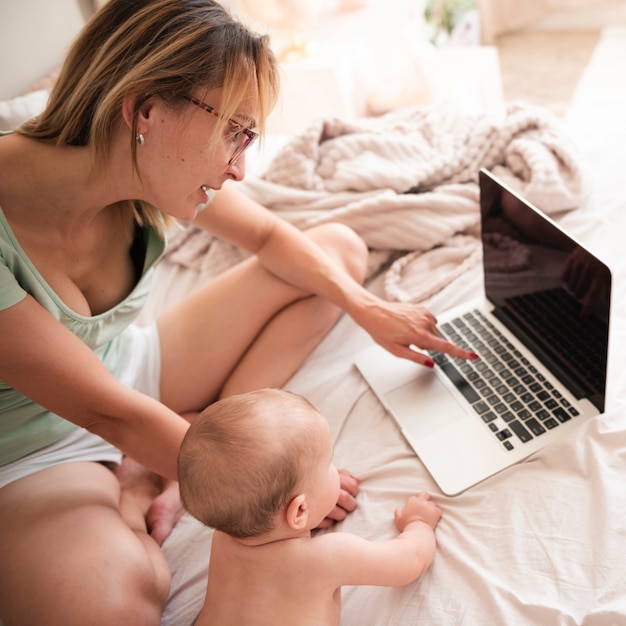 Mãe olhando para alto ângulo de laptop