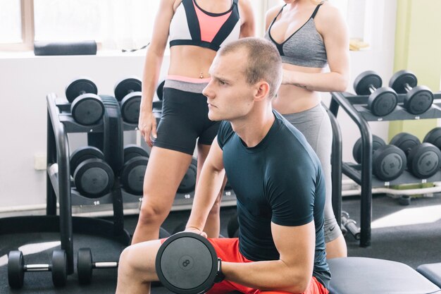 Man traing with dumbbell in gym