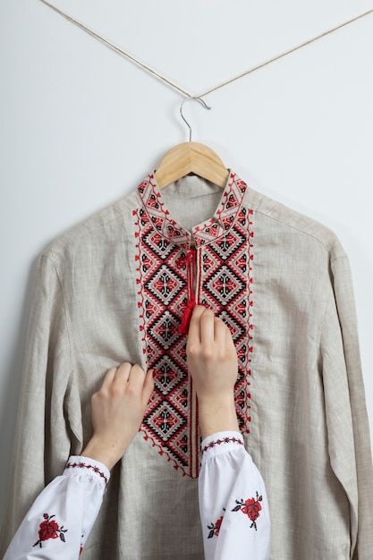 Foto grátis mãos organizando a camisa bordada tradicional