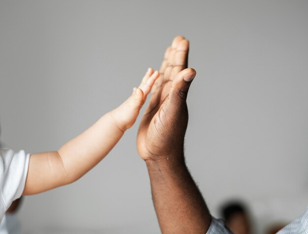 Mãos pequenas e grandes, fazendo um high five