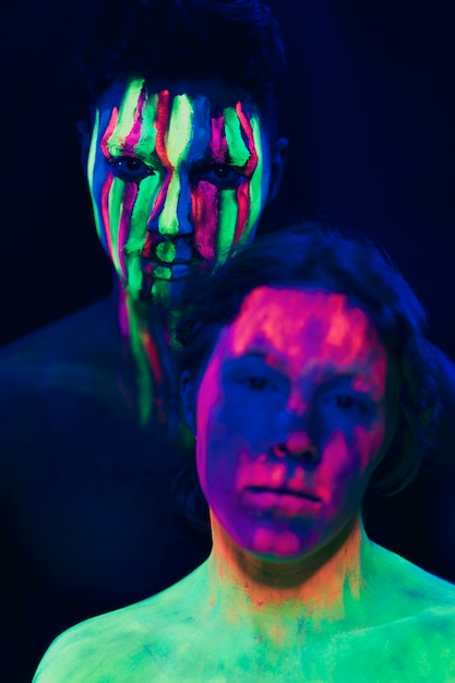 Maquiagem fluorescente no rosto de mulher e homem