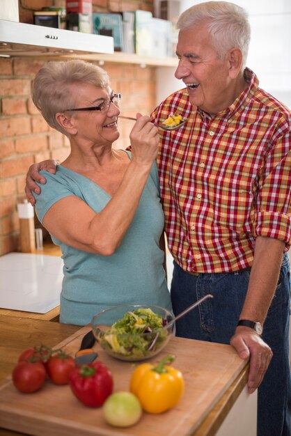 Marido provando uma salada de legumes caseira