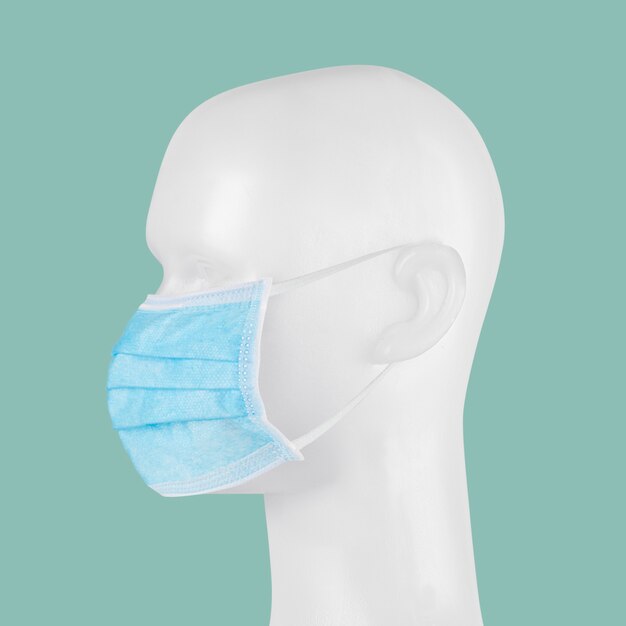 Máscara facial cirúrgica descartável azul em um manequim