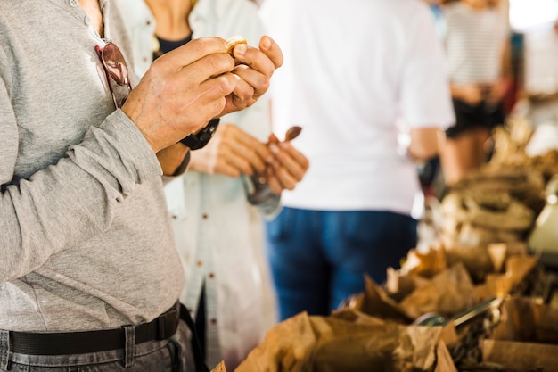 Masculino consumidor escolhendo data no mercado tenda