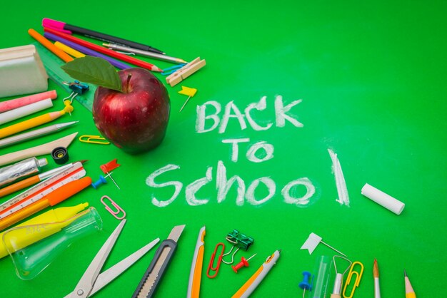 Material escolar no quadro verde &quot;Back to school background&quot;