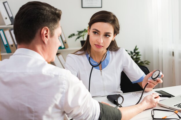 Médica, verificando a saúde do paciente